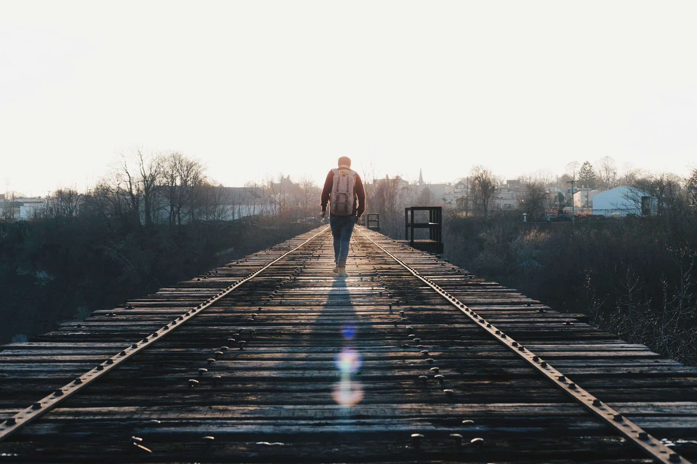 Man walking in the middle of rail road